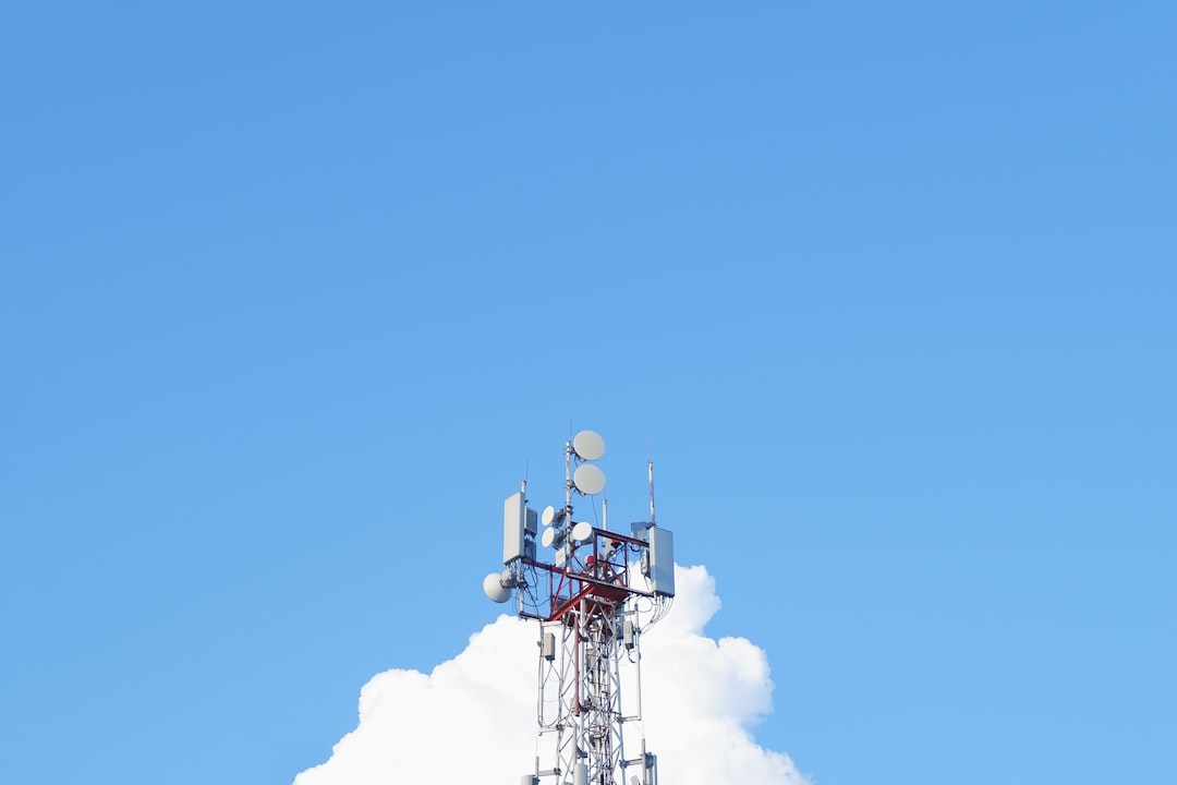 a-cell-phone-tower-with-a-blue-sky-in-the-background-xkdxdjwanl8